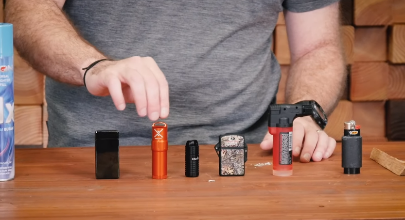 man comparing many lighters on a table