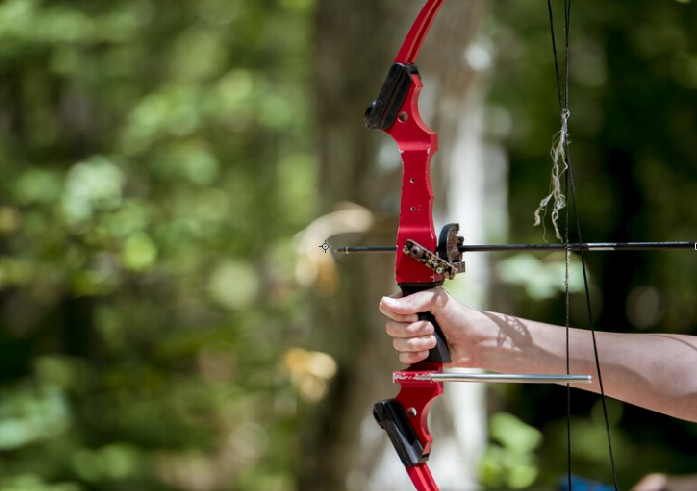 shot-of-a-person-holding-up-and-bow-and-arrow